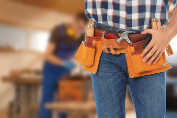 Sticker - Carpenter with tool belt in workshop, closeup