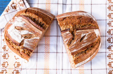 Traditional homemade sourdough bread loaf on a rustic background. Top view