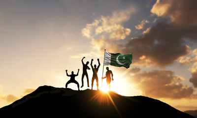 Wall Mural - A group of people celebrate on a mountain top with Pakistan flag. 3D Render