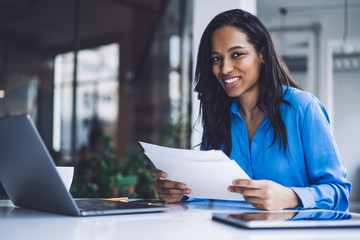 Black businesswoman doing paperwork in office