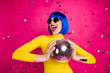 © deagreez - Photo of funny excited lady student party nightclub hold disco ball dancing queen confetti fall wear retro specs yellow turtleneck blue short wig isolated bright pink color background