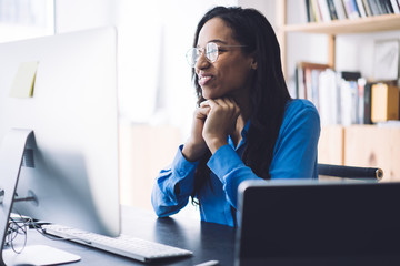 Smiling woman watching webinar on computer
