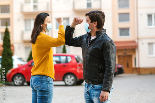 Young couple greeting with elbows Tableau sur Toile