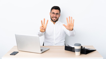 Wall Mural - Young businessman in a workplace counting eight with fingers