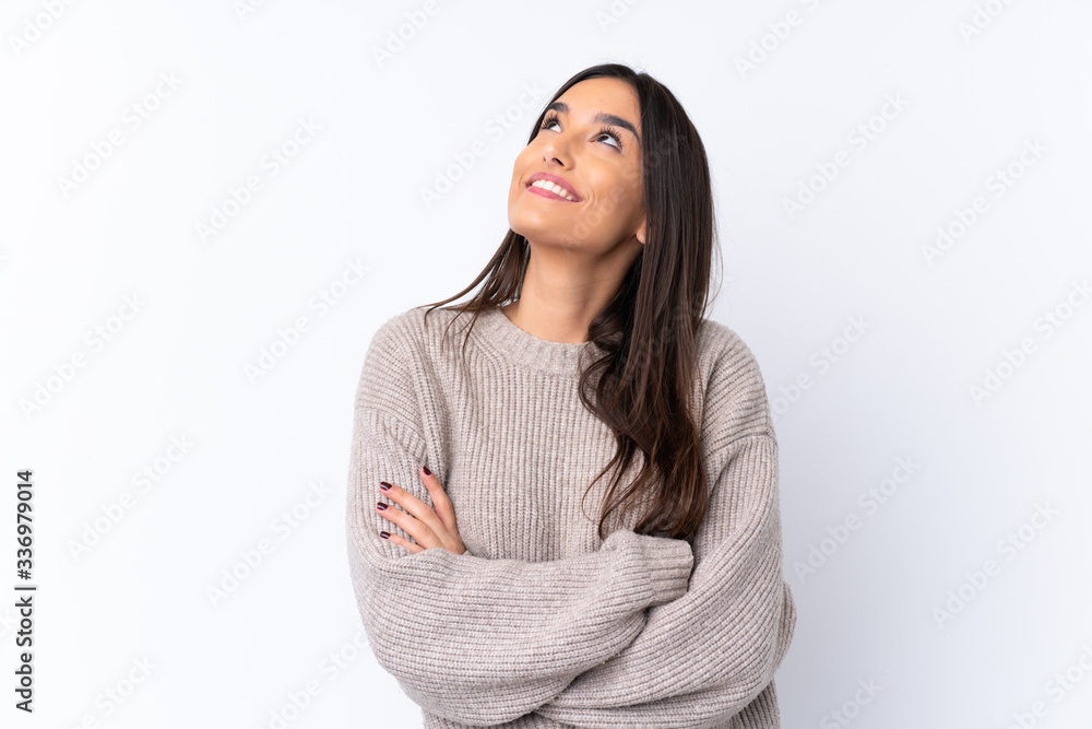 Young brunette woman over isolated white background looking up while smiling - obrazy, fototapety, plakaty 