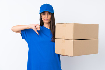 Young delivery woman over isolated white background showing thumb down sign