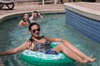 © kmlPhoto - Single mom with two daughters in a resort pool lazy river.