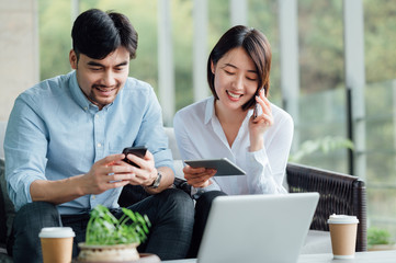 Wall Mural - Young Asian business man and woman