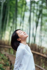 Wall Mural - Young Asian women in bamboo forest