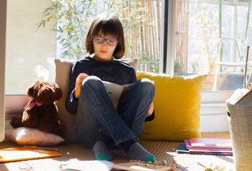 Wall Mural - studying child reading a book for homeschool while coronavirus lockdown