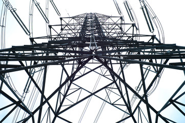 High angle view of high voltage electricity tower in sunny day with clear sky background