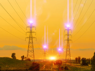 Sunset with a transmission tower, High voltage towers aganist the sunset background.