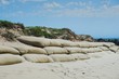 large burlap or hessian sandbags stopping soil erosion on a beach