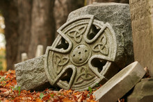 Fallen Celtic Headstones In Autumn Leaves.
