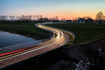 Wall Mural - Curve light trails on country road in the landscape of the province of Groningen, The Netherlands