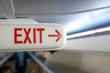 © MoiraM - Shallow depth of field image (selective focus) with the exit sign on the ceiling of a commercial airplane.