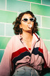 © visualspectrum/Stocksy - Female Teenager in Pink Tracksuit Blowing Bubblegum