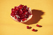 © Maki Company Limited/Stocksy - Closeup of pomegranate Seeds on a yellow background