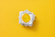 © Yaroslav Danylchenko/Stocksy - Stack of condom's packs on an yellow.
