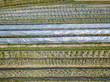 © Mario - Aerial view of plastic greenhouse on apple orchard. Plant cultivation in organic farming in Switzerland.