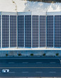 © Lawren Lu/Stocksy - Solar panels on the roof of factory on roadside