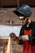 © Milles Studio/Stocksy - Focused man grinding metal frame