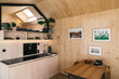 © visualspectrum/Stocksy - Wooden Tiny House Interior - Modern Kitchen With Smart Tech
