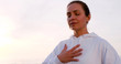 © Danil Nevsky/Stocksy - Adult female breathing with hand on chest