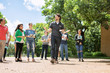 © Sean Locke Photography/Stocksy - Tour: Guide Leads Group Through College Campus