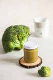Fototapeta Kuchnia -  Closed glass jar with baby food broccoli smoothie with space for text. Layout Baby food concept, first feeding.