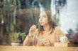 © hbrh - Daydreaming. woman looking upwards thinking of something nice in coffee shop