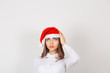 © hbrh - worried stressed overwhelmed young woman wearing red santa claus hat, looking up