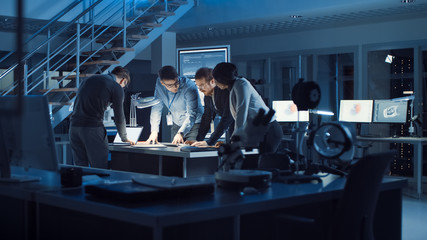 Poster - Diverse Team of Electronics Development Engineers Standing at the Desk Working with Documents, Solving Project Problems Late at Night. Specialists Working on Ultra Modern Industrial Design.