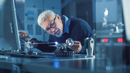 Poster - Portrait of Focused Middle Aged Engineer in Glasses Working with High Precision Laser Equipment, Using Lenses and Testing Optics for Accuracy Required Electronics