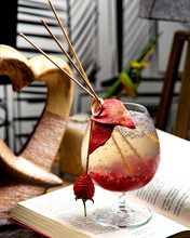 A Glass Of Cocktail With Dragon Fruit And Strawberry