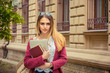© hbrh - Happy student. Closeup portrait headshot professional beautiful confident young girl business woman holding books isolated outdoor university school cityscape background. Multicultural mixt race