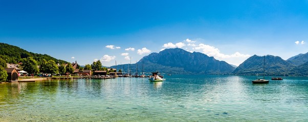 Beautiful view on Attersee lake im Salzkammergut, alps mountain, boat, sailboat in by Unterach. Upper Austria, nearby Salzburg.