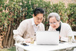 © JodieWang - Asian aged couple using a laptop
