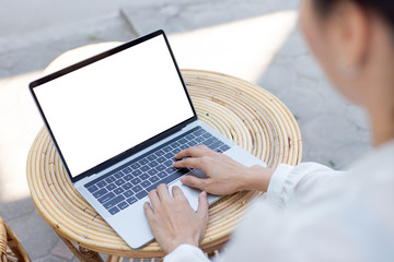 computer mockup image blank screen with white background for advertising text,hand woman using laptop contact business search information on desk at coffee shop.marketing and creative design