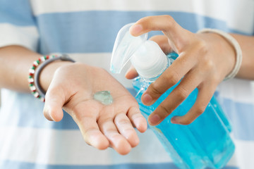  Hands sanitizer alcohol gel.  Woman use for cleaning hands and protect from Corona Virus, COVID-19.