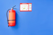 Fire extinguisher and evacuation plan on color background