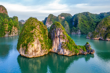 Wall Mural - Aerial view floating fishing village and rock island, Halong Bay, Vietnam, Southeast Asia. UNESCO World Heritage Site. Junk boat cruise to Ha Long Bay. Popular landmark, famous destination of Vietnam