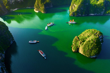 Aerial view floating fishing village and rock island, Halong Bay, Vietnam, Southeast Asia. UNESCO World Heritage Site. Junk boat cruise to Ha Long Bay. Popular landmark, famous destination of Vietnam