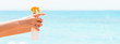 © sosiukin - Croped image of woman's hand holding sunblock spray at the beach