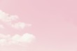 Beautiful white soft fluffy clouds on a pale pink sky background