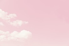 Beautiful White Soft Fluffy Clouds On A Pale Pink Sky Background