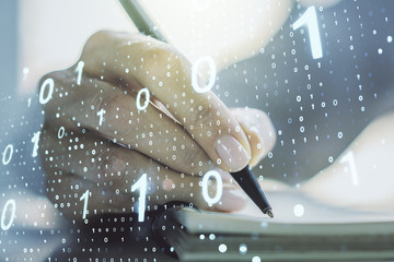 Creative abstract binary code hologram and woman hand writing in diary on background, AI and machine learning concept. Multiexposure