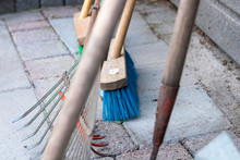 Close Up Of Some Gardening Tools. Focused On A Broom. Tools To Clean Up A Garden.