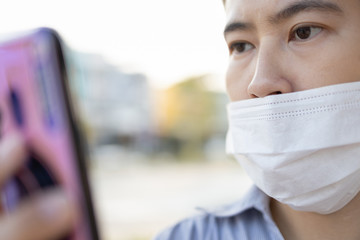 Asian woman with protective mask,cover her mouth and not close her nose,female people wear face mask that is wrong,incorrectly protected,pandemic of Coronavirus,risk of flu,Covid-19 virus infections