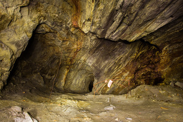 Abandoned copper ore mine underground tunnel with yellow dirt